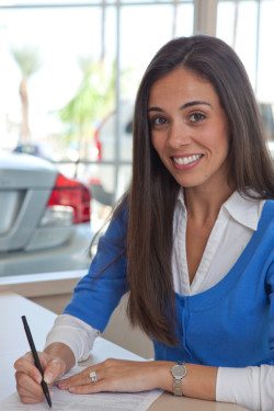 Portrait of woman signing papers
